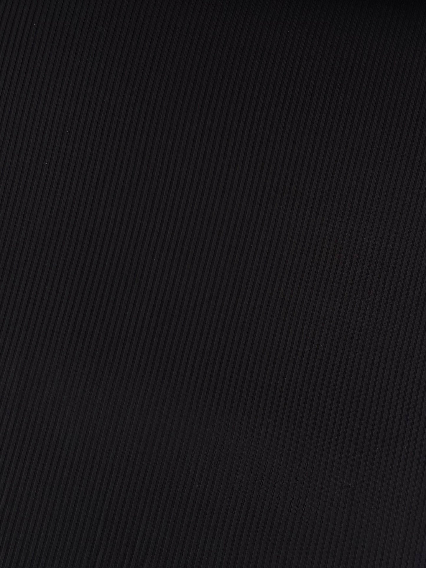 Close-up of black textured fabric on a white background