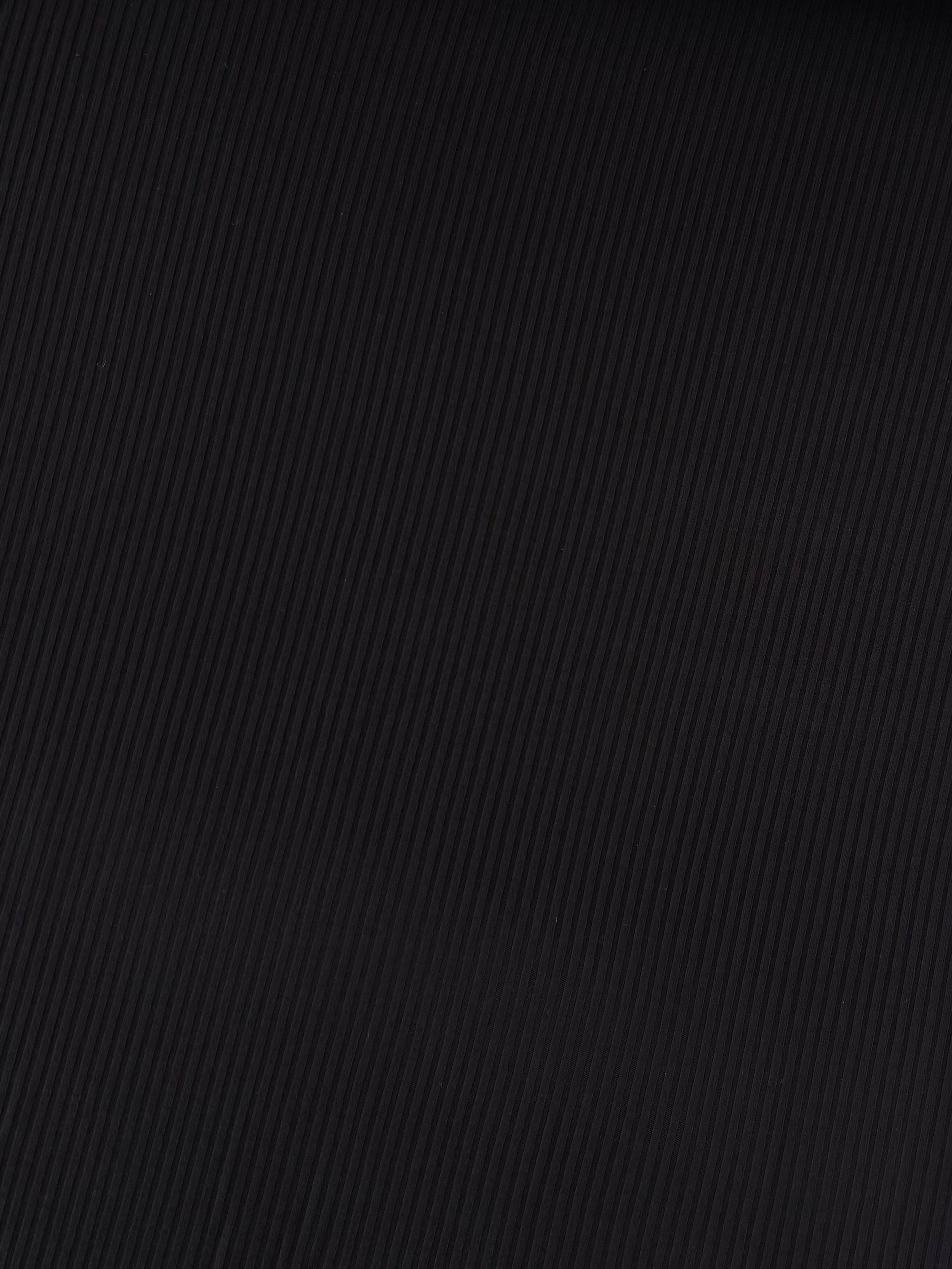 Close-up of black textured fabric on a white background