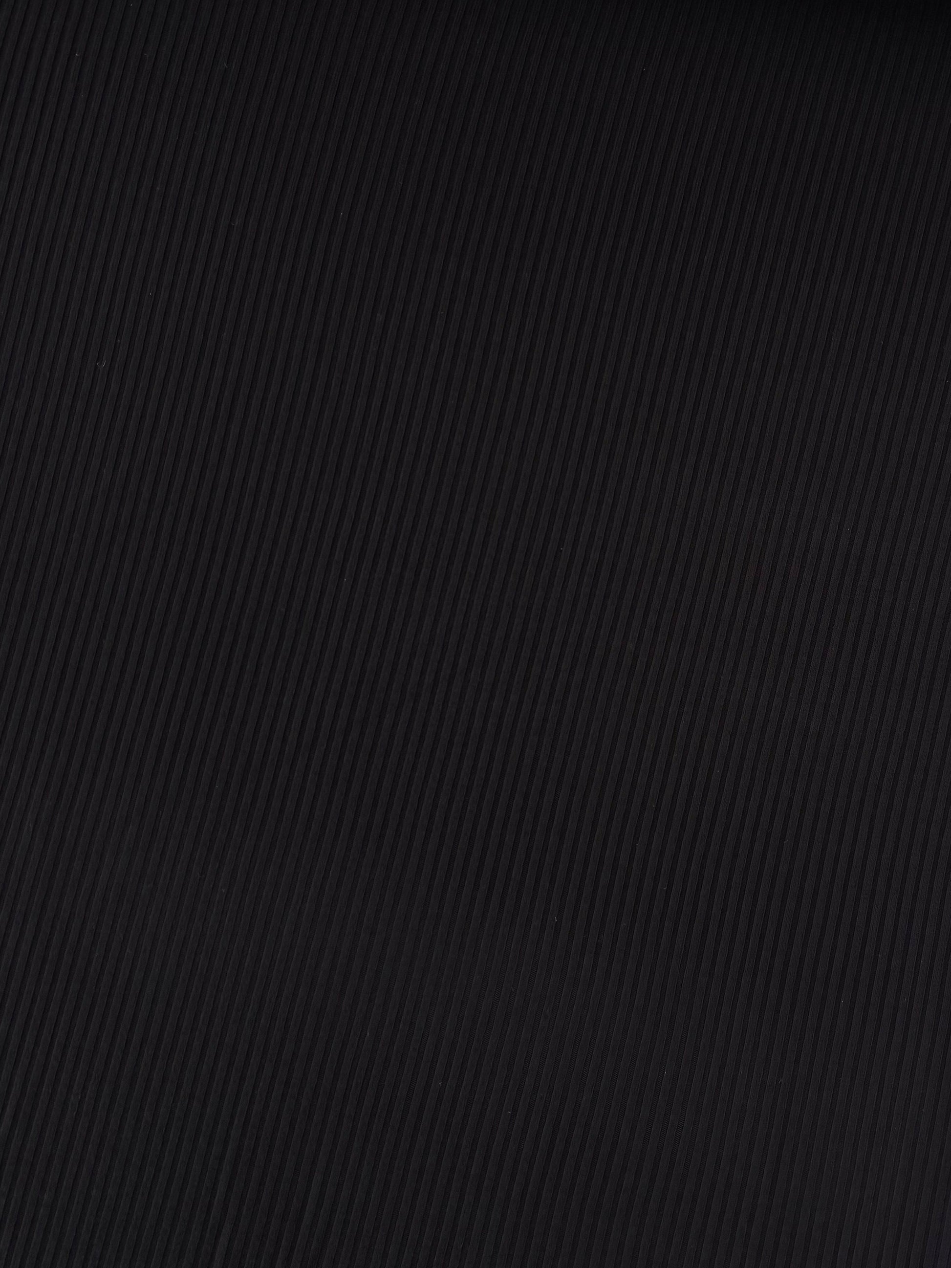 Close-up of black textured fabric on a white background