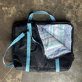 Black briefcase made with blue straps with corner folded down to show lining
