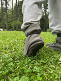 Person wearing a gray pants with high cuffs in a grassy area